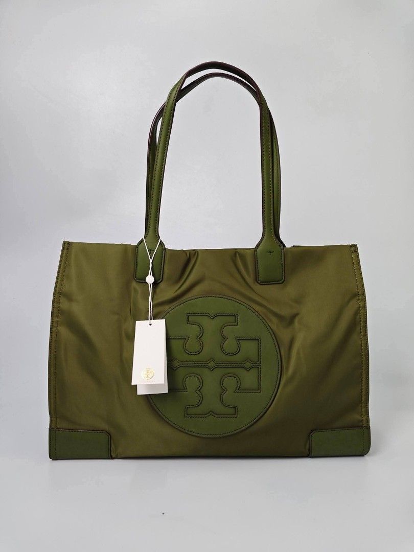 Authentic Tory Burch Olive Green Nylon Tote Bag (Category: Tote Bags) located in Quezon City. Submitted by hollowwillow (Listing ID 1467616468, Image 1). Description: - Brand: Tory Burch - Condition: Brand new - Material: Durable green nylon with leather trim - Design: Large embroidered logo on the front - Straps: Comfortable double shoulder straps - Interior: Spacious with multiple zip and slip pockets for easy organization - 100% Authentic and 