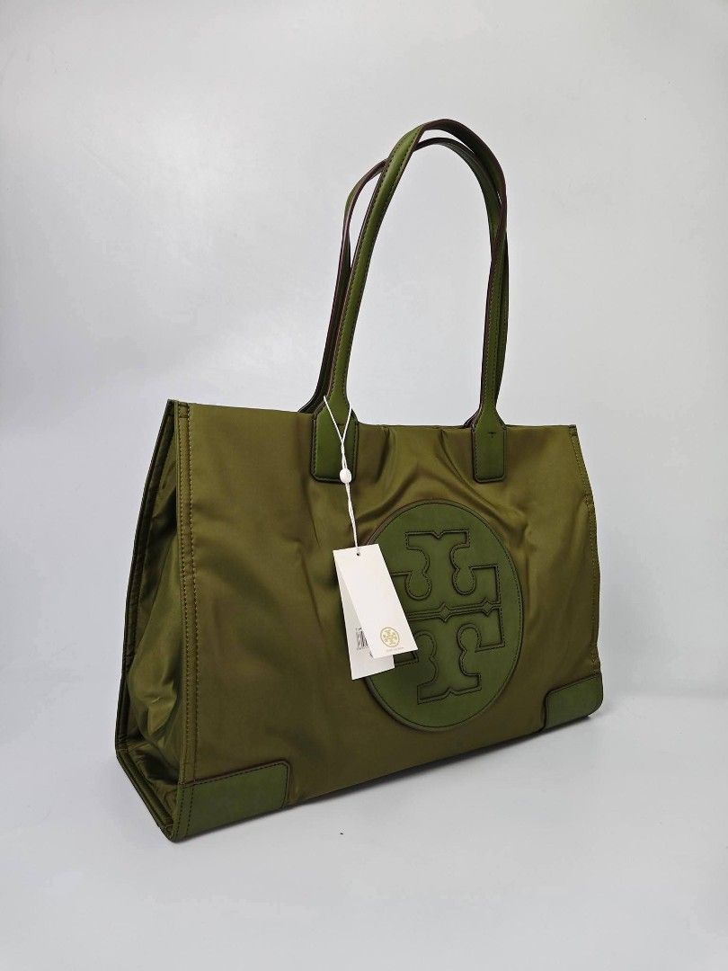 Authentic Tory Burch Olive Green Nylon Tote Bag (Category: Tote Bags) located in Quezon City. Submitted by hollowwillow (Listing ID 1467616468, Image 2). Description: - Brand: Tory Burch - Condition: Brand new - Material: Durable green nylon with leather trim - Design: Large embroidered logo on the front - Straps: Comfortable double shoulder straps - Interior: Spacious with multiple zip and slip pockets for easy organization - 100% Authentic and 