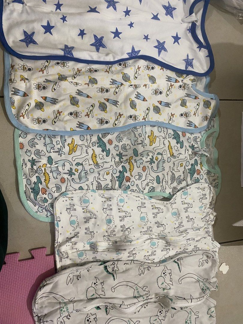 Baby Swaddle Sleep Sacks Assorted Prints Bundle Set (Category: Babies & Kids Fashion) located in Makati City. Submitted by micay1031 (Listing ID 1467659425, Image 1). Description: - Set of 5 baby swaddle sleep sacks - Adorable prints: blue stars, outer space rockets, dinosaurs, and elephants - Made from soft, breathable cotton material - Convenient zip-up design for quick and easy nighttime diaper changes - Keeps your baby cozy, secure, and comfo