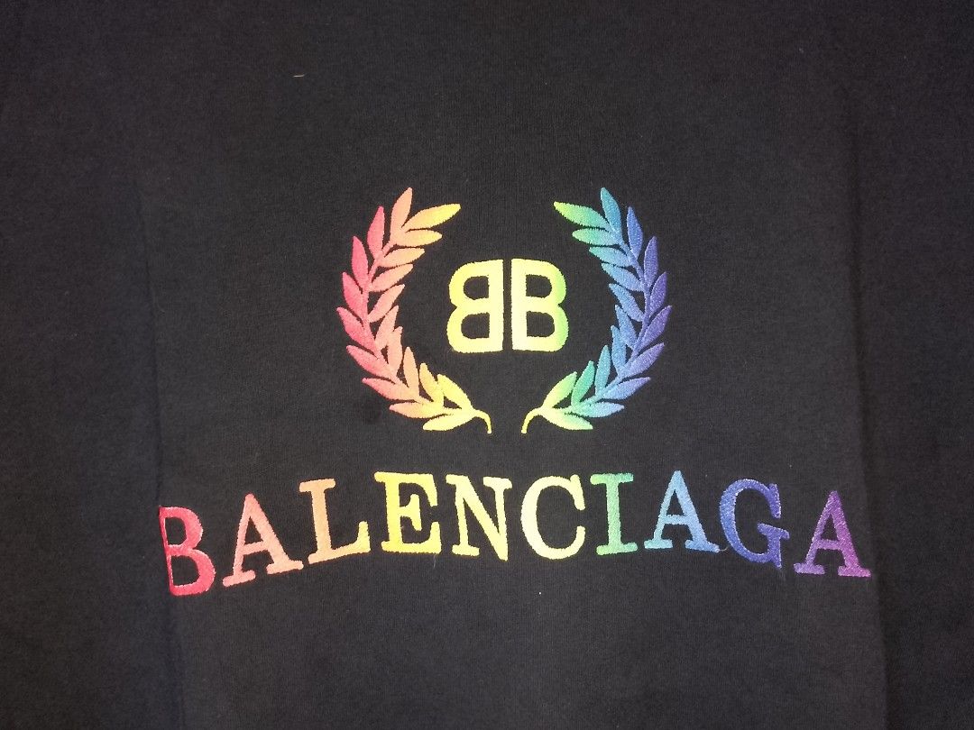 Balenciaga Rainbow Laurel Tee Black Size L (Category: Activewear) located in Manila. Submitted by mjthrifted_second (Listing ID 1467640086, Image 3). Description: - Authentic Balenciaga black t-shirt - Size: Large (tag attached to inner collar) -Dimes: 25/30 - Features a colorful rainbow embroidered laurel wreath logo across the chest - Crafted in Portugal - Classic relaxed fit for a stylish streetwear look - Condition: Excellent.