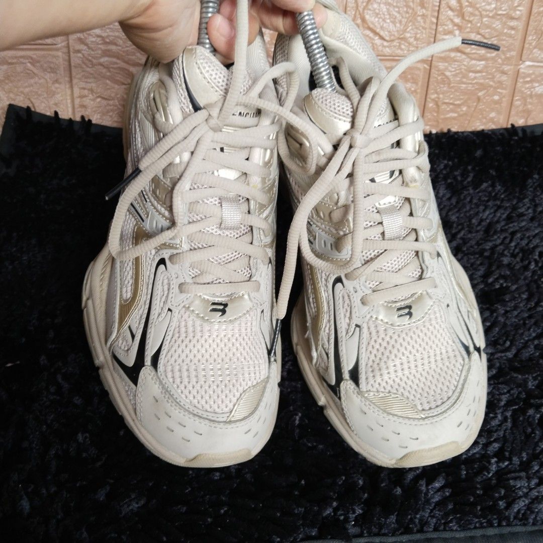 Balenciaga Xpander Chunky Sneaker Neutral Cream (Category: Sneakers) located in Lubao. Submitted by dione_closet503 (Listing ID 1467613279, Image 2). Description: - Style: Trendy chunky sneakers in a neutral cream tone with chic metallic gold and black panel details - Design: Distinctive cut-out heel architecture with breathable mesh uppers and lace-up closure - Comfort & Durability: Thick athletic soles with solid grip and sturdy construction fo