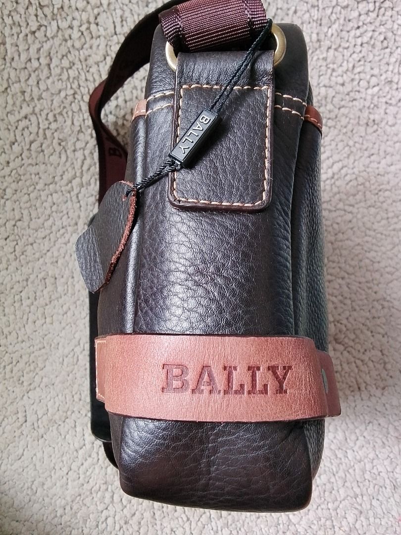 Bally Brown Leather Crossbody Bag (Category: Luxury Bags & Wallets) located in Las Pinas. Submitted by flyhigh23 (Listing ID 1467683949, Image 2). Description: - Brand: Bally - Material: Rich brown pebbled leather with contrasting lighter brown trim - Condition: Brand new with tag attached - Strap: Adjustable fabric strap with comfortable leather shoulder pad - Pockets: Front exterior magnetic pocket, interior zip pocket, and slip pockets - Closu