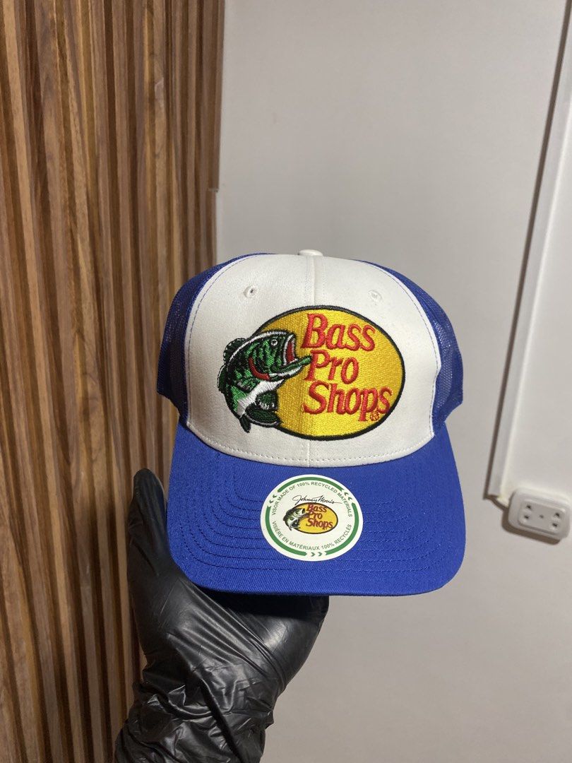 Bass Pro Shops Trucker Hat Blue White (Category: Caps & Hats) located in Caloocan City. Submitted by heatedcaps4425 (Listing ID 1467804028, Image 1). Description: - Brand: Bass Pro Shops - Color: Blue and white - Condition: Brand new with sticker still attached on the flat brim - Features: Breathable mesh back panels and adjustable snapback closure - Design: Classic embroidered bass logo patch on the front.