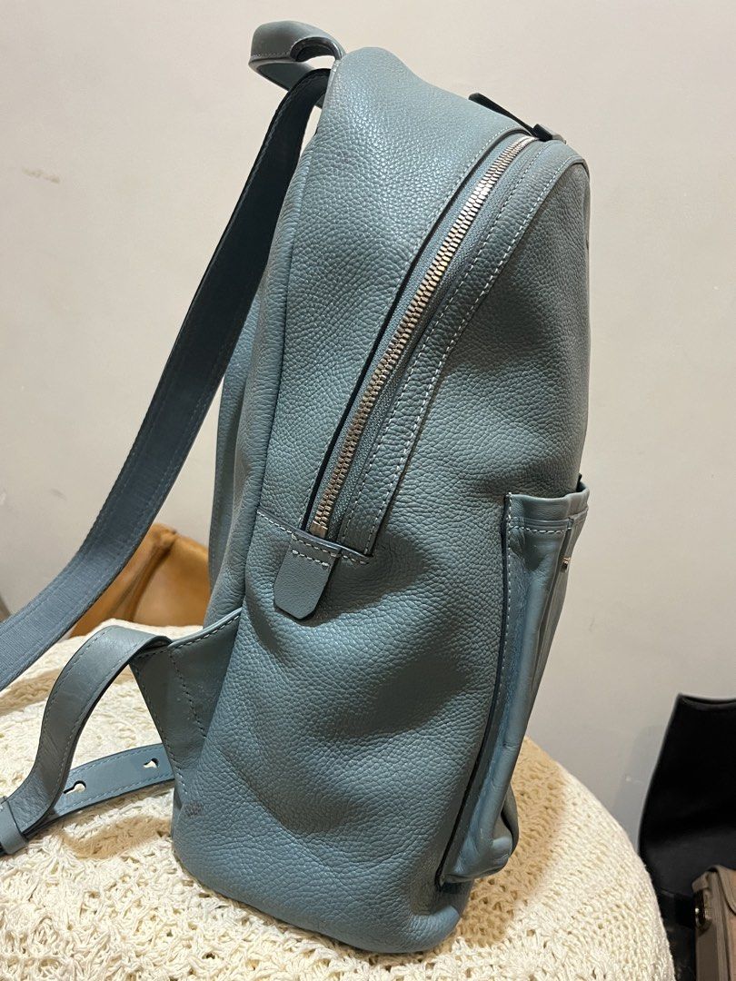 Bean Pole Light Blue Leather Backpack (Category: Backpacks) located in Bacolod City. Submitted by vintage_vogue6100 (Listing ID 1467745563, Image 2). Description: - Brand: Bean Pole - Color: Light blue - Material: Textured leather - Dimensions: 36cm (H) x 30cm (L) x 13cm (W) - Closure: Top zip - Features: Front pocket, clean interior, sturdy straps - Condition: Good overall with visible scuffing and wear marks at the bottom front pocket area.