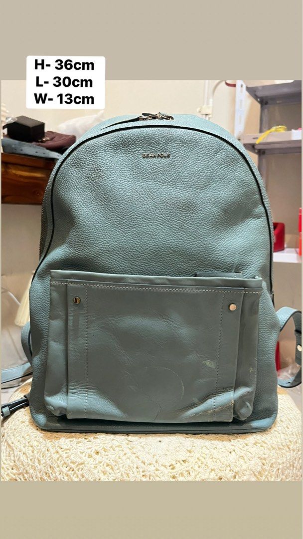 Bean Pole Light Blue Leather Backpack (Category: Backpacks) located in Bacolod City. Submitted by vintage_vogue6100 (Listing ID 1467745563, Image 1). Description: - Brand: Bean Pole - Color: Light blue - Material: Textured leather - Dimensions: 36cm (H) x 30cm (L) x 13cm (W) - Closure: Top zip - Features: Front pocket, clean interior, sturdy straps - Condition: Good overall with visible scuffing and wear marks at the bottom front pocket area.