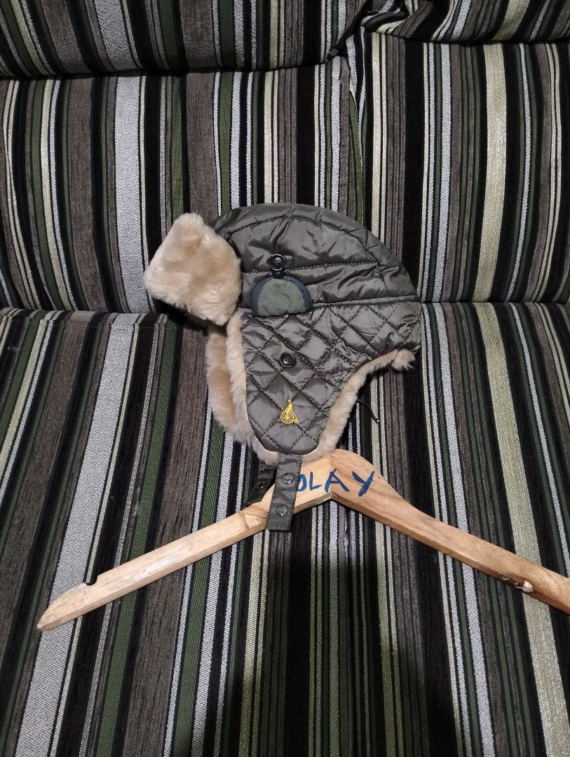 Beanpole Olive Green Quilted Trapper Hat Size M (Category: Caps & Hats) located in Taguig. Submitted by conniemdcruz (Listing ID 1467727645, Image 2). Description: Beanpole trapper hat in olive green. Quilted outer shell with fluffy faux fur lining and ear flaps. Size M. Shell, lining, and filler are 100% polyester, contrast is 85% acrylic and 15% polyester. Yellow embroidered branding on the back and small yellow bicycle emblem on the side. Made