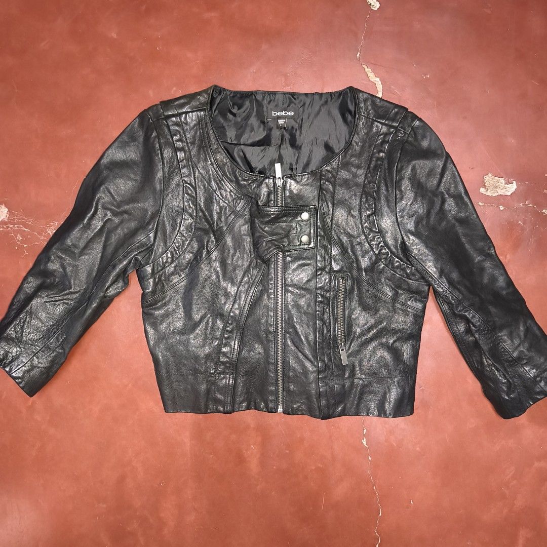 bebe Black Leather Jacket Size L (Category: Coats, Jackets and Outerwear) located in Antipolo. Submitted by alphaomega_fox (Listing ID 1467707329, Image 1). Description: - Brand: bebe - Size: L (Tag attached at inner collar) - Color: Black - Closure: Asymmetrical front zipper with snap button lapel - Pockets: Zippered pocket on the left chest - Details: Zippers near sleeve cuffs, fully lined black interior - Condition: excellent condition 17x19 3