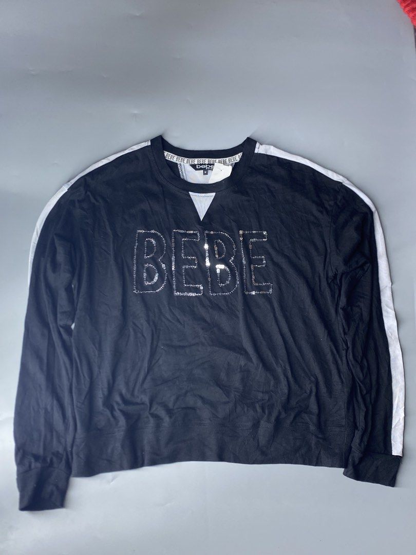 Bebe Sport Black Sequined Logo Sweatshirt Medium (Category: Coats, Jackets and Outerwear) located in Dagupan City. Submitted by vell25apparel (Listing ID 1467827879, Image 2). Description: Black long sleeve sweatshirt by Bebe Sport. Size medium. Large silver sequin BEBE letters sparkling across the chest. White side stripes down both sleeves. Contrast white ribbed v-insert at the neckline. Branded taping inside the collar. Soft cotton material. T