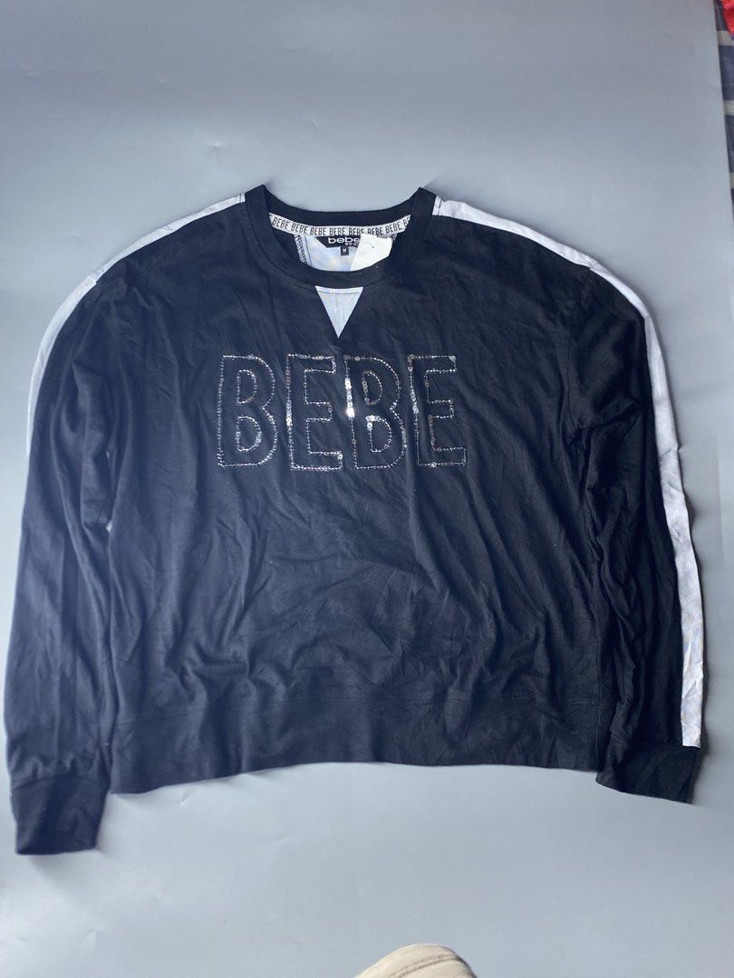 Bebe Sport Black Sequined Logo Sweatshirt Medium (Category: Coats, Jackets and Outerwear) located in Dagupan City. Submitted by vell25apparel (Listing ID 1467827879, Image 1). Description: Black long sleeve sweatshirt by Bebe Sport. Size medium. Large silver sequin BEBE letters sparkling across the chest. White side stripes down both sleeves. Contrast white ribbed v-insert at the neckline. Branded taping inside the collar. Soft cotton material. T