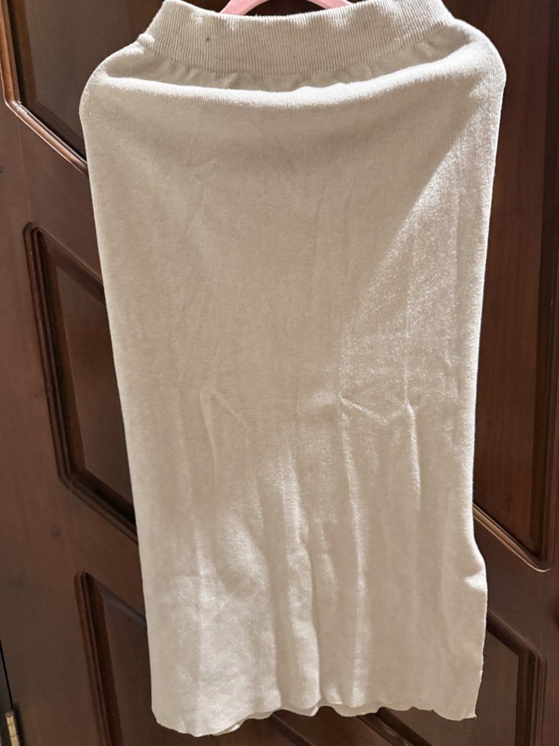 Beige Knitted Midi Skirt with Side Slit (Category: Skirts) located in Mandaluyong City. Submitted by riz_040521 (Listing ID 1467674544, Image 3). Description: - Color: Neutral beige - Material: Stretchy knit fabric that hugs the body - Details: Comfortable ribbed waistband and stylish side slit for easy walking - Style: Versatile basic piece, easy to dress up or down - Pairing: Matches with almost any top in your closet.
