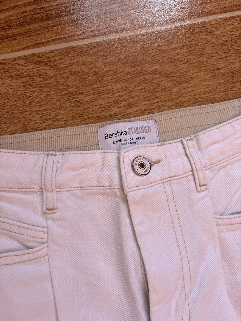 Bershka Pinstripe Trousers (Category: Other Bottoms) located in Manila. Submitted by _foryou (Listing ID 1467672607, Image 3). Description: - Brand: Bershka - Style: Tailored pants with beige pinstripe side panels and back - Color: White with beige pinstripes - Size: EUR 36, USA 04, MEX 26 - Origin: Made in Turkey - Features: Front button closure, belt loops, front pockets, and a single back welt pocket - Condition: Excellent, ready to wear.