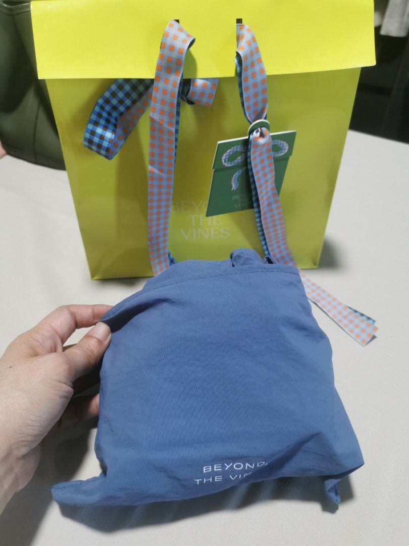 Beyond The Vines Blue Dumpling Bag (Category: Shoulder Bags) located in Makati City. Submitted by denvergirl1119 (Listing ID 1467835227, Image 2). Description: - Brand: Beyond The Vines - Item: Blue Dumpling Bag - Condition: Brand new with tags (BNWT) - Inclusions: Comes with original paper gift bag - Material: Lightweight nylon - Features: Super roomy, dual handles, front pocket with printed logo, and drawstring top closure - Style: Great everyd