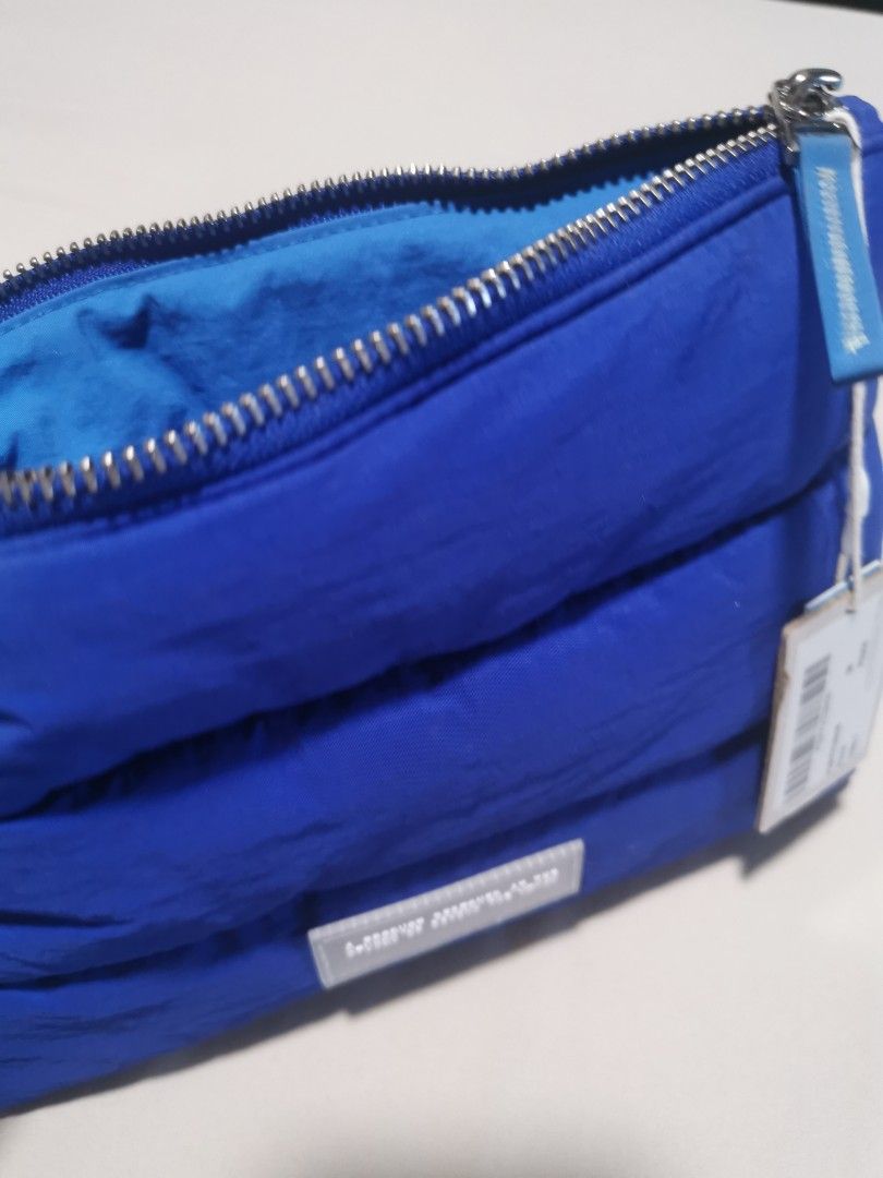 Beyond The Vines Poofy Pouch Blue (Category: Purses & Pouches) located in Makati City. Submitted by denvergirl1119 (Listing ID 1467834194, Image 3). Description: - Authentic Beyond The Vines Poofy Pouch in Blue - Brand new, pristine condition with original tags attached - Comes with the official Beyond The Vines paper bag - Trendy quilted puffer exterior with a secure zipper closure - Blue interior lining featuring a convenient inner pocket - Per