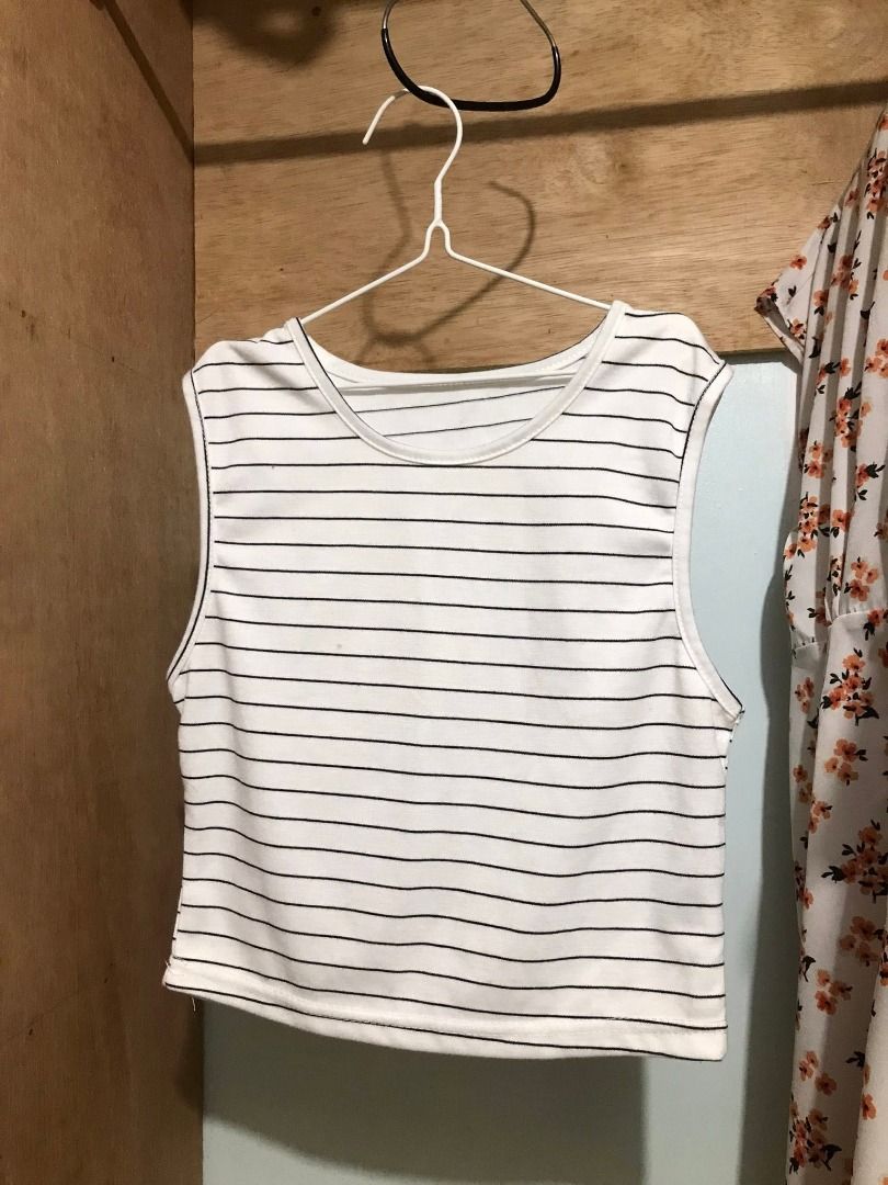 Black and white striped sleeveless crop top (Category: Sleeveless) located in Quezon City. Submitted by ezrakeith (Listing ID 1467808513, Image 1). Description: - Color: White with thin black horizontal stripes - Style: Sleeveless crop top with scoop neckline - Length: Short/waist-length - Fabric: Lightweight and comfortable for warm weather - Versatility: Easy to pair with high-waisted jeans, skirts, or shorts - Finish: Clean finish along hems a