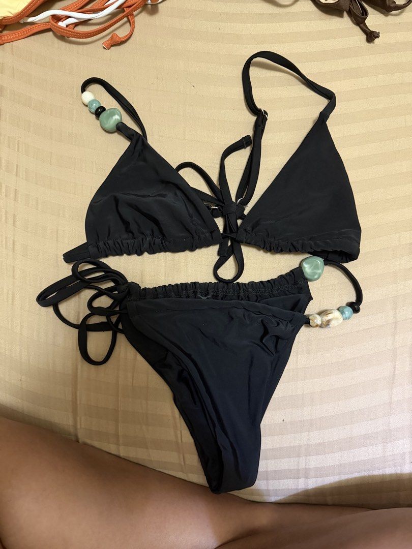Black bikini set with beaded straps (Category: Bikinis & Swimsuits) located in Marikina City. Submitted by lmgl30 (Listing ID 1467742366, Image 2). Description: - Style: Black two-piece bikini set with a minimalist look - Top: Adjustable triangle top with unique green and white stone beads on the straps - Bottoms: Adjustable tie-side design for a custom fit - Ideal for: Beach days, pool parties, and tropical vacations - Condition: USED ONCE NO FO