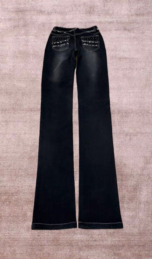 Black Bootcut Jeans Studded Y2K (Category: Jeans) located in Ibaan. Submitted by jiara_18 (Listing ID 1467729689, Image 3). Description: - Size: 27 with an 8.1-inch rise -Length: 38 - Wash: Black wash denim with subtle fading down the legs - Details: White contrast stitching and edgy metal stud embellishments on pockets - Unique Feature: Trendy animal print patterned trim along the waistband and back pockets.