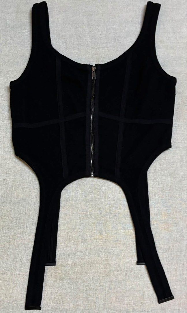 Black combat corset tank top (Category: Sleeveless) located in Santo Domingo. Submitted by royal.teresa (Listing ID 1467702333, Image 1). Description: -combat corset tank top in black -front zipper closure -suspender hem detail -corset inspired silhouette with vertical boning style panels that contour the torso -can fit S-M.