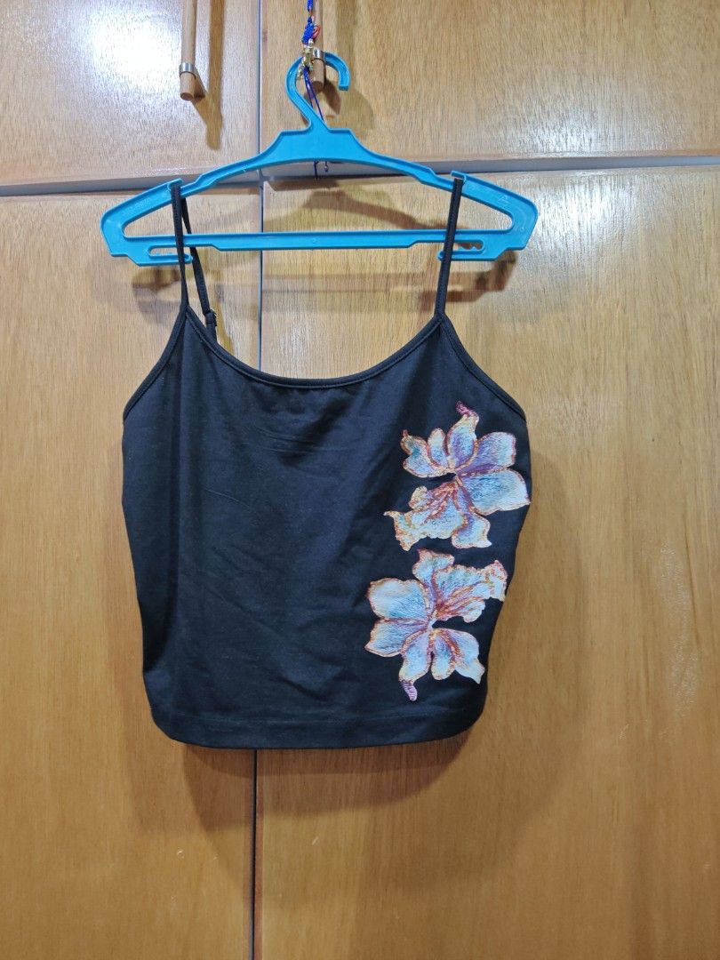 Black floral embroidered crop top cami spaghetti strap (Category: Sleeveless) located in Caloocan City. Submitted by grandfish.db3ec8 (Listing ID 1467744899, Image 2). Description: - Color: Black with light blue and pink floral embroidery - Style: Cami crop top with spaghetti straps and straight back - Fabric: Lightweight and comfortable - Fit: Perfect for pairing with high-waisted bottoms - Condition: Brand new / Excellent.