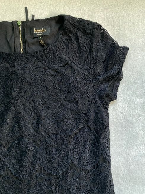 Black Lace Dress (Category: Dresses) located in Rizal. Submitted by sheeraay (Listing ID 1467673284, Image 3). Description: - Brand: Laundry by Shelli Segal - Size: 6 - Color: Black - Design: Intricate crochet-style lace pattern - Details: Round neckline, short sleeves, and exposed gold zipper at the upper back - Lining: Fully lined interior.