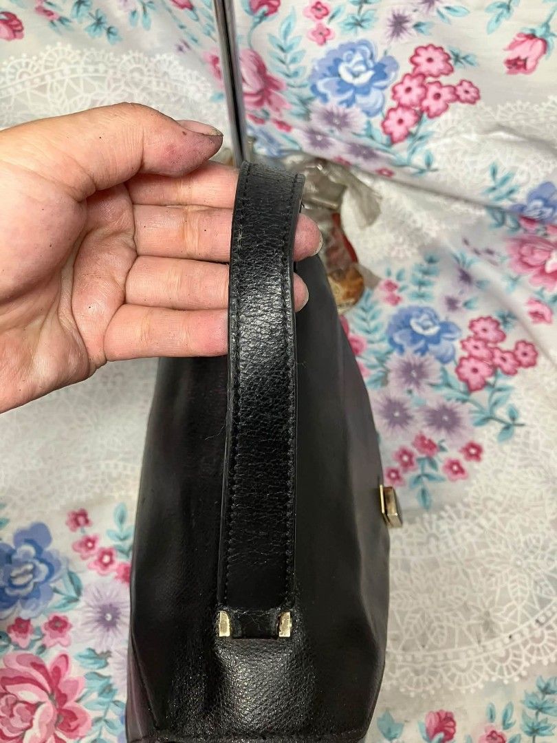 Black Leather Structured Handbag Made in Italy (Category: Luxury Bags & Wallets) located in Manila. Submitted by boldfire_315559 (Listing ID 1467662455, Image 3). Description: - Style: Black textured leather handbag with classic top handle - Hardware: Elegant gold-tone accents - - Closure: Front flap with vertical strap lock - Interior: Cream lining with a convenient zippered pocket - Authenticity: Made in Italy stamp with serial number N 400341 