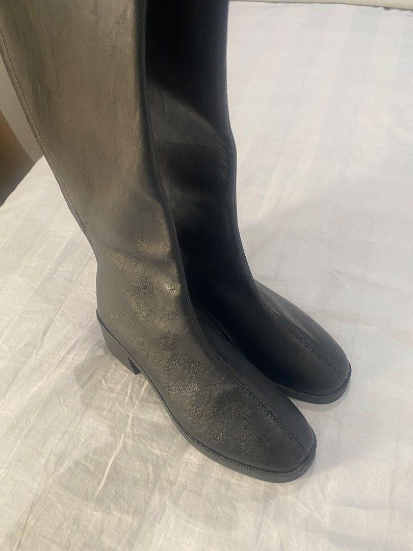 Black Long Boots Knee High (Category: Boots) located in Dasmarinas. Submitted by closetcleanser_ (Listing ID 1467706773, Image 2). Description: - Size: 39 - Style: Knee-high boots with chunky block heels and rounded toes - Closure: Back zip for easy wear - Versatility: Great to style with skirts or skinny jeans for cooler weather.