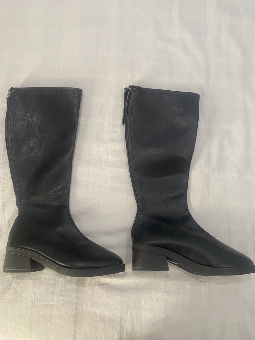 Black Long Boots Knee High (Category: Boots) located in Dasmarinas. Submitted by closetcleanser_ (Listing ID 1467706773, Image 3). Description: - Size: 39 - Style: Knee-high boots with chunky block heels and rounded toes - Closure: Back zip for easy wear - Versatility: Great to style with skirts or skinny jeans for cooler weather.