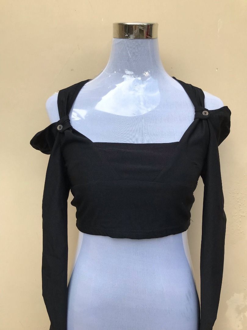 Black Long Sleeve Off Shoulder Crop Top (Category: Longsleeves) located in Quezon City. Submitted by ezrakeith (Listing ID 1467807664, Image 1). Description: - Color: Black - Style: Long-sleeve crop top with a fitted cut - Neckline: Square neck with unique shoulder strap detailing - Accents: Stylish buttons near the collarbone - Fabric: Comfortable material with a slight texture - Perfect pairing: Great with high-waisted jeans or skirts - Conditi