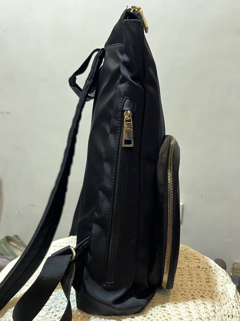 Black Nylon Backpack with Gold Zippers (Category: Backpacks) located in Bacolod City. Submitted by vintage_vogue6100 (Listing ID 1467760772, Image 3). Description: - Color & Material: Sleek black nylon with shiny gold hardware - Organization: Multiple compartments including a front zippered pocket with mesh dividers and elastic loops - Dimensions: Height 40cm, Length 32cm, Width 11cm - Comfort: Adjustable shoulder straps and convenient top grab h