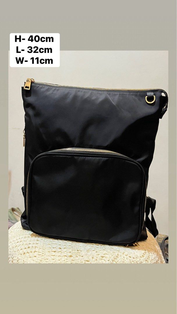 Black Nylon Backpack with Gold Zippers (Category: Backpacks) located in Bacolod City. Submitted by vintage_vogue6100 (Listing ID 1467760772, Image 1). Description: - Color & Material: Sleek black nylon with shiny gold hardware - Organization: Multiple compartments including a front zippered pocket with mesh dividers and elastic loops - Dimensions: Height 40cm, Length 32cm, Width 11cm - Comfort: Adjustable shoulder straps and convenient top grab h