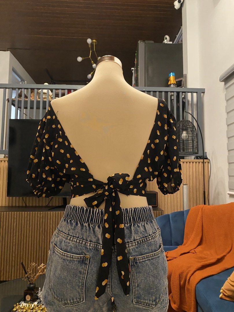 Black Polka Dot Tie-Back Crop Top Puff Sleeve (Category: Blouses) located in Caloocan City. Submitted by yzaaaaaviles (Listing ID 1467784281, Image 2). Description: - Color/Pattern: Black with all-over yellow polka dots - Neckline: Sweetheart neckline with front tie detail - Sleeves: Puff sleeves with comfortable elastic cuffs - Back Design: Dramatic low V-back with a bottom tie closure - Material: Lightweight and breathable, ideal for warm weath