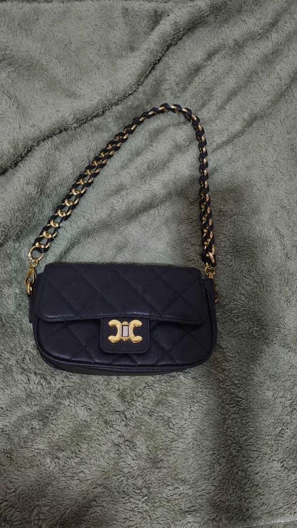 Black Quilted Shoulder Bag with Gold Hardware (Category: Luxury Bags & Wallets) located in Caloocan City. Submitted by warmfox_1bc5f2 (Listing ID 1467686127, Image 1). Description: - Color & Material: Classic black quilted leather with clean fabric lining - Closure: Secure flap with a striking gold-toned center clasp - Strap: Elegant intertwined chain and black leather shoulder strap - Size: Compact and practical for everyday outings and essentia