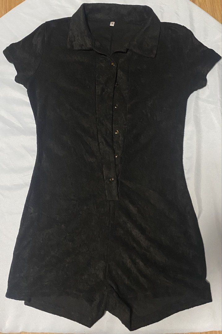 Black short sleeve button front collared romper size S (Category: Rompers) located in Paranaque City. Submitted by pomeloluvr (Listing ID 1467680033, Image 2). Description: - Color: Black - Size: S - Material: Soft Corduroy Like Textured fabric - Design: Collar neckline with tortoiseshell front buttons - Fit: Fitted waist with attached shorts - Condition: Clean hems and tidy stitching throughout.