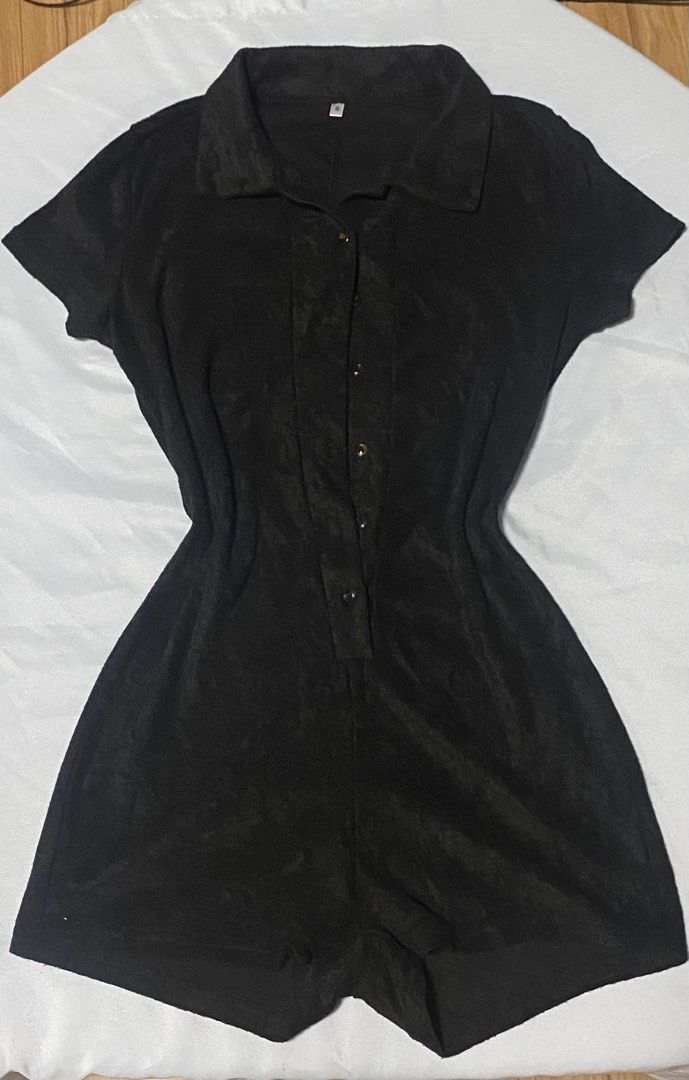Black short sleeve button front collared romper size S (Category: Rompers) located in Paranaque City. Submitted by pomeloluvr (Listing ID 1467680033, Image 1). Description: - Color: Black - Size: S - Material: Soft Corduroy Like Textured fabric - Design: Collar neckline with tortoiseshell front buttons - Fit: Fitted waist with attached shorts - Condition: Clean hems and tidy stitching throughout.