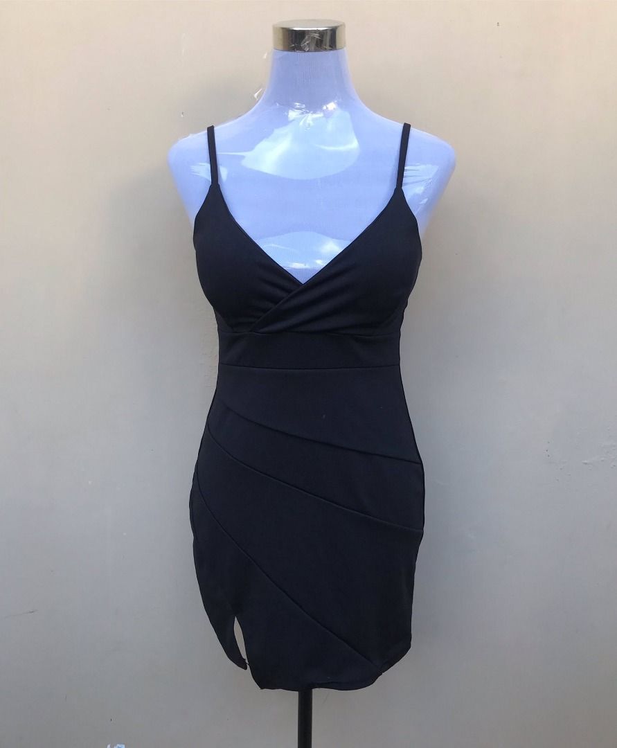 Black Spaghetti Strap Bodycon Mini Dress (Category: Dresses) located in Quezon City. Submitted by ezrakeith (Listing ID 1467807794, Image 1). Description: - Color: Black - Style: Bodycon mini dress with fitted silhouette - Neckline: V-neck with wrapped crossover bodice - Details: Diagonal pleated panels on the skirt and a chic front side slit - Straps: Adjustable spaghetti straps - Material: Stretchy, body-hugging fabric - Condition: Excellent / 
