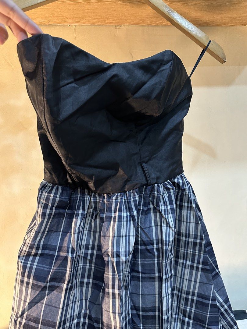 Black Strapless Plaid Mini Dress (Category: Dresses) located in Manila. Submitted by tenshiii185 (Listing ID 1467677622, Image 2). Description: - Style: Strapless black top with blue and white plaid flared skirt - Design: Structured bodice with thin strap accents and lightweight fabric - Fit: Flattering flared silhouette for casual outings or parties - Versatility: Easy to style with your favorite boots or heels - Condition: Brand new / Excellent