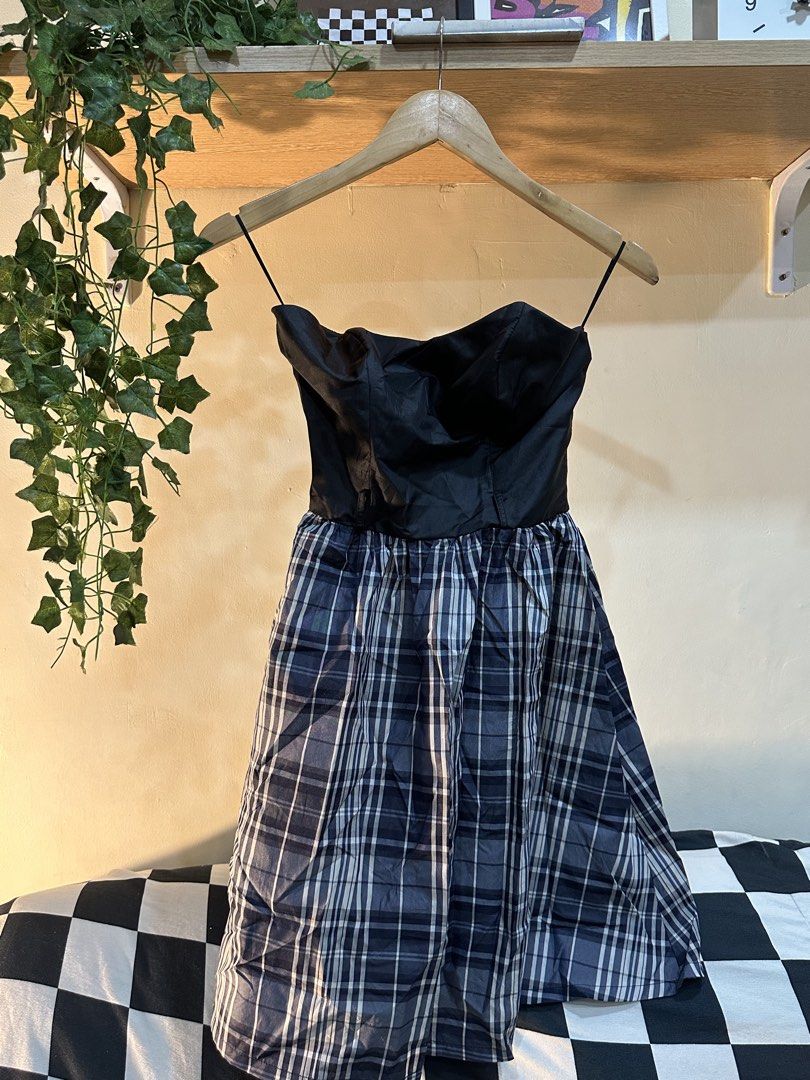 Black Strapless Plaid Mini Dress (Category: Dresses) located in Manila. Submitted by tenshiii185 (Listing ID 1467677622, Image 1). Description: - Style: Strapless black top with blue and white plaid flared skirt - Design: Structured bodice with thin strap accents and lightweight fabric - Fit: Flattering flared silhouette for casual outings or parties - Versatility: Easy to style with your favorite boots or heels - Condition: Brand new / Excellent