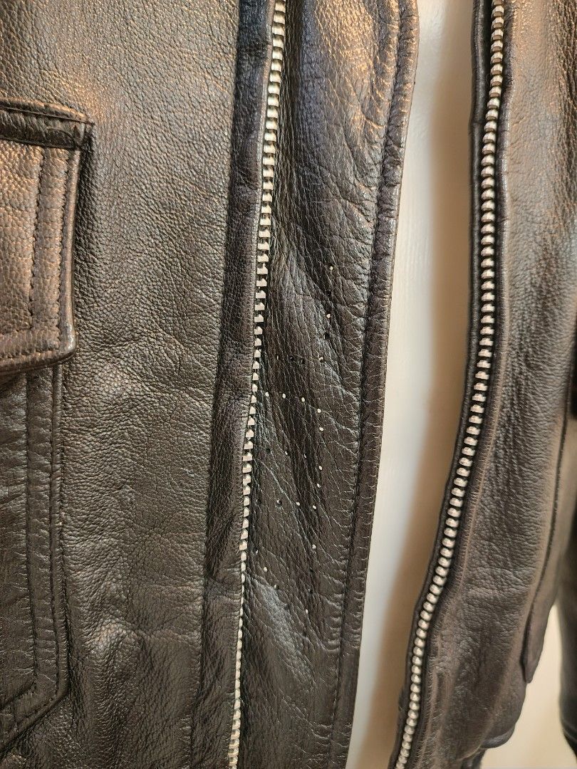 Black USN Leather Bomber Jacket (Category: Coats, Jackets and Outerwear) located in La Trinidad. Submitted by padasem_kadi (Listing ID 1467646221, Image 2). Description: - Style: Vintage-inspired black leather jacket - Collar: Detachable black faux shearling collar for versatile styling - Comfort & Fit: Ribbed cuffs and hem to block out the wind - Storage: Front button-flap pockets for your daily essentials - Hardware: Durable heavy-duty metal fr