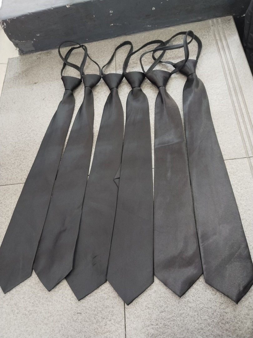 Black Zipper Ties Formal Neckties (Category: Ties) located in Manila. Submitted by zdmal (Listing ID 1467623627, Image 1). Description: - Color: Classic plain black - Design: Built-in zipper mechanism (no tying needed, easy to put on and take off) - Finish: Smooth fabric with a subtle shine - Size: Standard width blade - Ideal for: School uniforms, formal events, and office wear - Condition: Neat and ready to use - Stock: Multiple pieces availabl