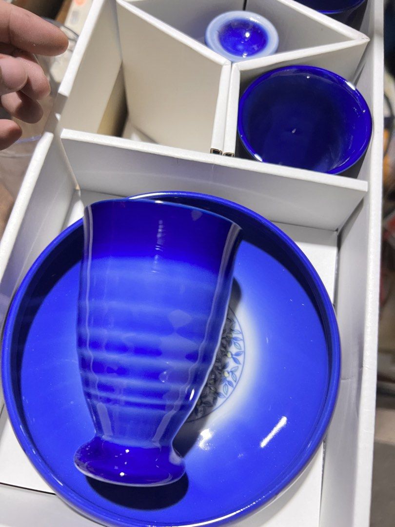 Blue and White Ceramic Cup and Plate Gift Set (Category: Dinnerware & Cutlery) located in Manila. Submitted by suarezbaby04975 (Listing ID 1467726731, Image 2). Description: - Deep blue ceramic matching set - Includes 4 cups, 1 small holder, and 1 large serving plate - Beautiful floral wreath pattern in the center of the plate - Ideal for daily tea time or serving snacks - Packed in original white presentation box, great for gifts Carefully packe