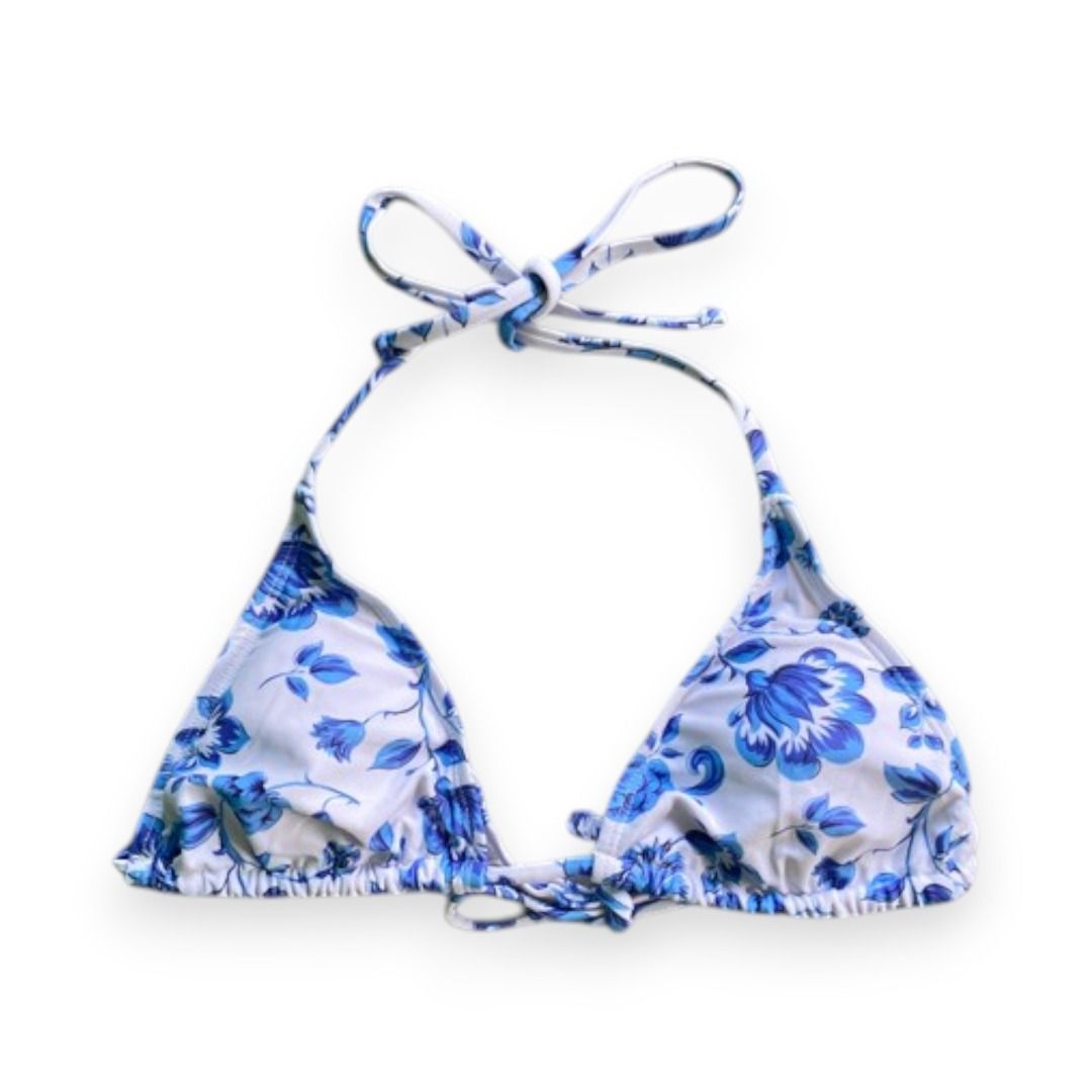 Blue and White Floral Halter Bikini Top (Category: Bikinis & Swimsuits) located in Rizal. Submitted by sheeraay (Listing ID 1467646814, Image 1). Description: - Style: Halter neck bikini top with adjustable neck and back ties - Design: Blue and white floral print with triangular cups - Details: Gathered fabric along the bottom band - Condition: Excellent, clean fabric with no stains or loose threads.