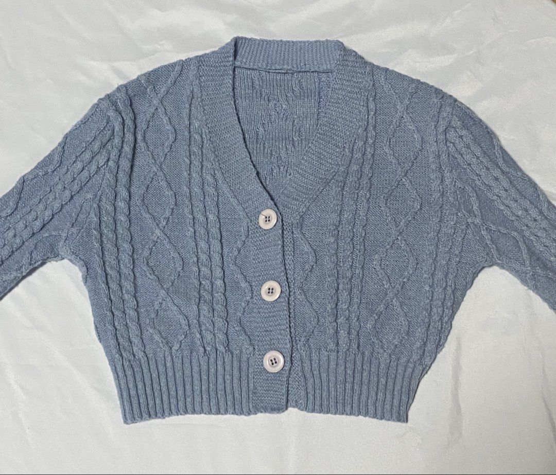 Blue Cable Knit Button Up Cropped Cardigan (Category: Longsleeves) located in Paranaque City. Submitted by pomeloluvr (Listing ID 1467677828, Image 2). Description: - Color: Light blue - Design: Classic cable pattern - Fit: Cropped - Neckline: V-neck with 3 front buttons - Details: Ribbed cuffs and hem .