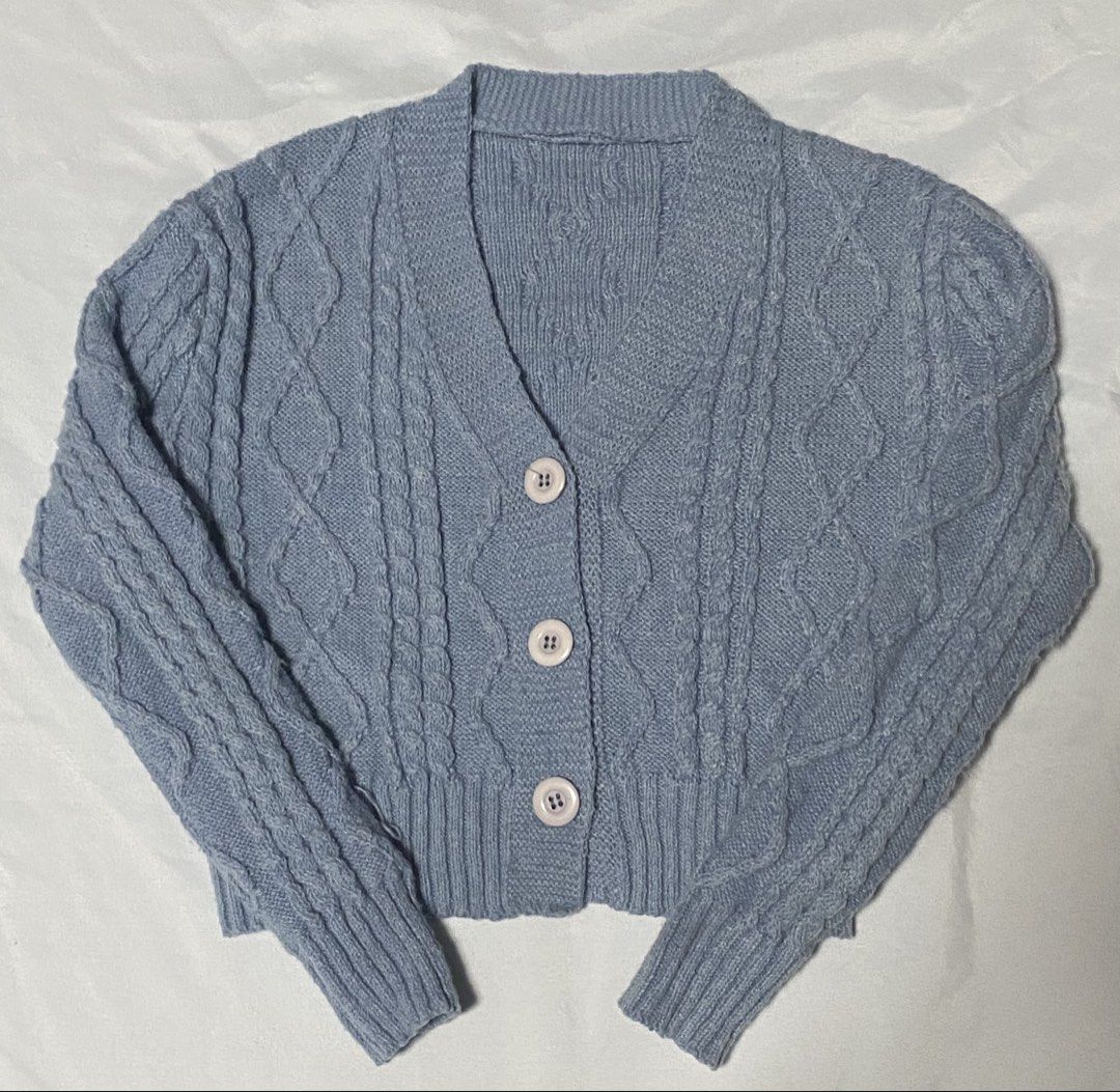Blue Cable Knit Button Up Cropped Cardigan (Category: Longsleeves) located in Paranaque City. Submitted by pomeloluvr (Listing ID 1467677828, Image 1). Description: - Color: Light blue - Design: Classic cable pattern - Fit: Cropped - Neckline: V-neck with 3 front buttons - Details: Ribbed cuffs and hem .