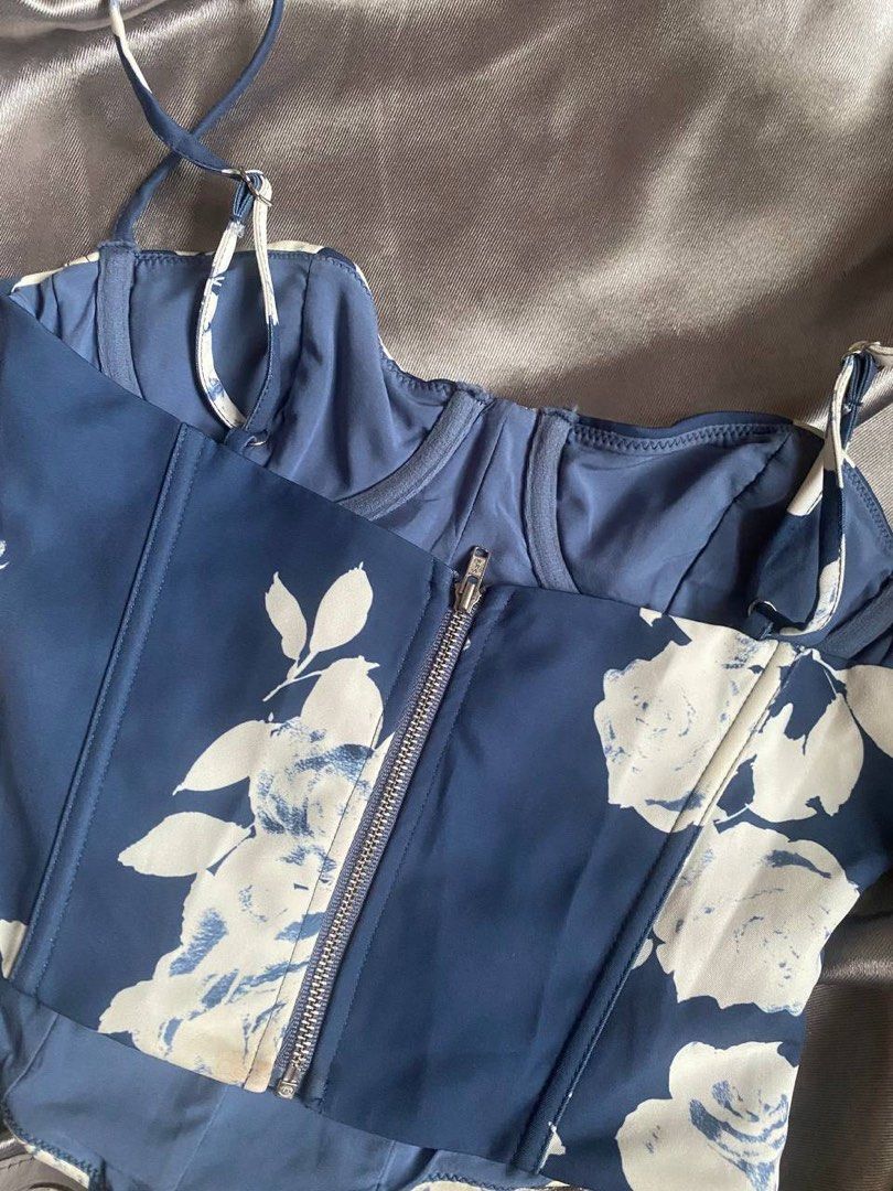 White Fox Blue Floral Corset Bustier Top (Category: Sleeveless) located in Cagayan de Oro. Submitted by curated_closetph (Listing ID 1467767051, Image 3). Description: — Size : XS — Color: Blue / White — White rose floral patterns on a deep blue base — Structured boning for a defined waist — Padded underwire cups for lift and support — Pointed dip hem to accentuate the waist — Adjustable spaghetti straps — Exposed metallic back zipper closure — C