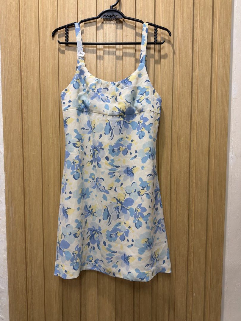 Blue floral spaghetti strap mini dress (Category: Dresses) located in Bacoor. Submitted by preloved_with_love_ (Listing ID 1467611183, Image 1). Description: - White mini dress with a blue and yellow floral print - Scoop neckline with flattering front gathering - Adjustable spaghetti straps with stylish rectangular buckles - Concealed back zipper closure - Lightweight, sleeveless, and perfect for warm weather.