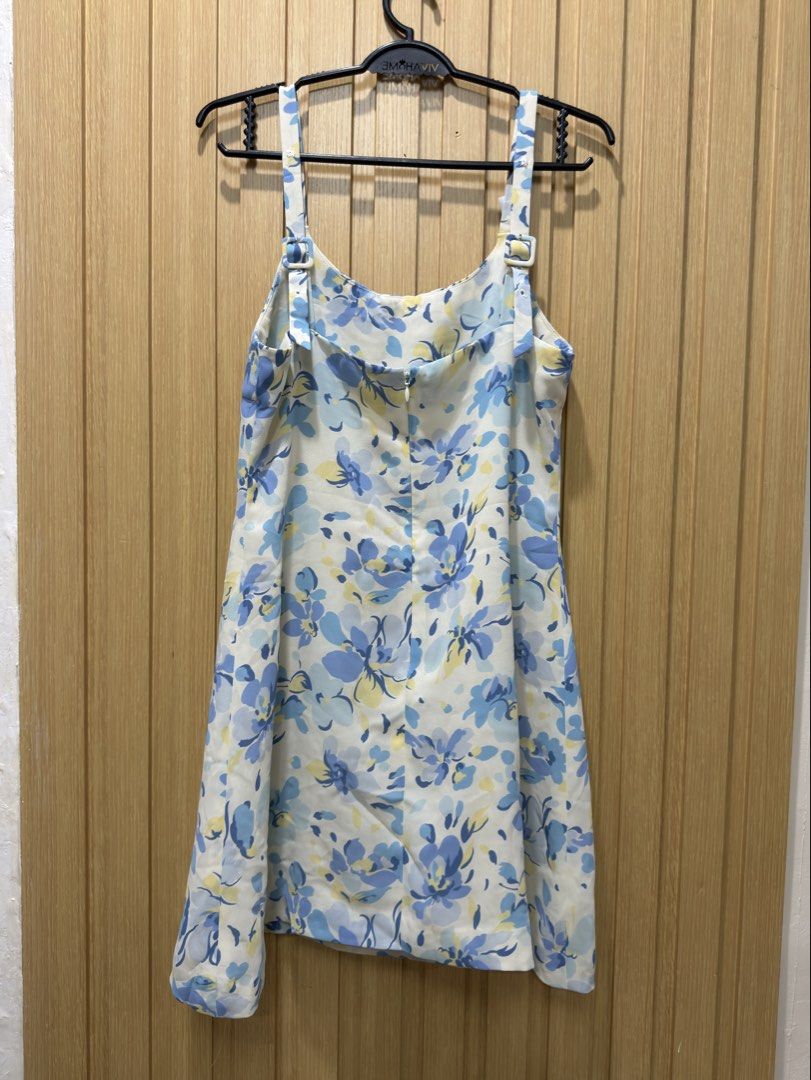 Blue floral spaghetti strap mini dress (Category: Dresses) located in Bacoor. Submitted by preloved_with_love_ (Listing ID 1467611183, Image 3). Description: - White mini dress with a blue and yellow floral print - Scoop neckline with flattering front gathering - Adjustable spaghetti straps with stylish rectangular buckles - Concealed back zipper closure - Lightweight, sleeveless, and perfect for warm weather.