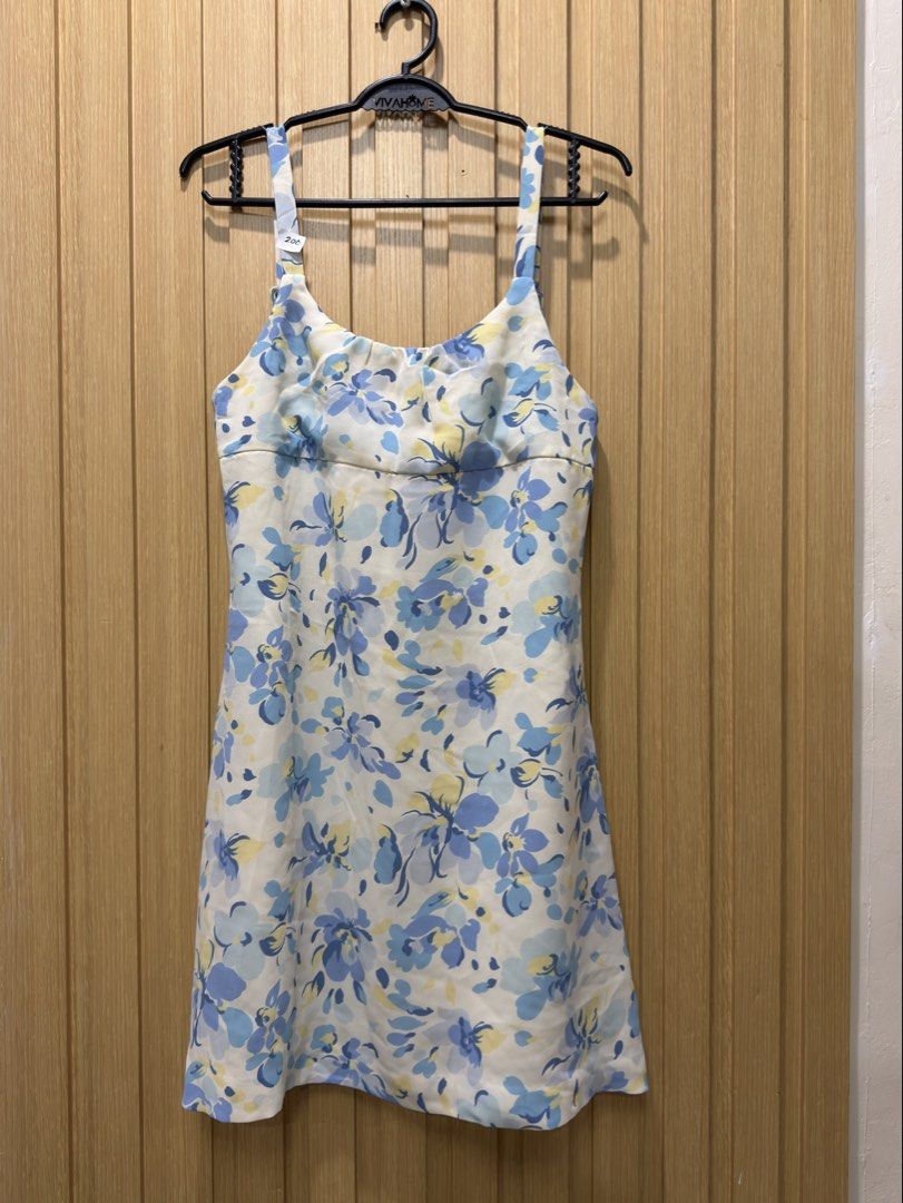 Blue floral spaghetti strap mini dress (Category: Dresses) located in Bacoor. Submitted by preloved_with_love_ (Listing ID 1467611183, Image 2). Description: - White mini dress with a blue and yellow floral print - Scoop neckline with flattering front gathering - Adjustable spaghetti straps with stylish rectangular buckles - Concealed back zipper closure - Lightweight, sleeveless, and perfect for warm weather.