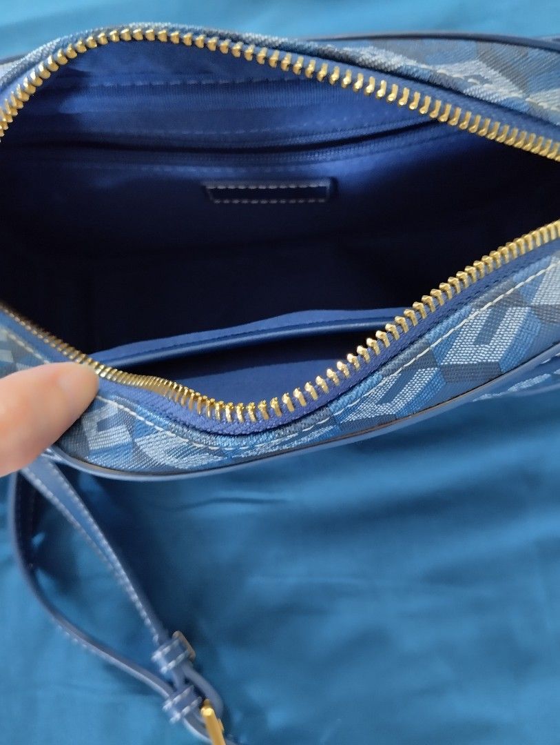 Blue Geometric Print Crossbody Bag (Category: Cross-body Bags) located in Subic. Submitted by starvi (Listing ID 1467610979, Image 2). Description: - Trendy blue crossbody bag with a modern geometric cube pattern - Secure top zip closure and a front button-tab pocket for quick access - Comfortable, adjustable blue shoulder strap with elegant gold hardware - Dark blue fabric-lined interior featuring an internal slip pocket and zippered compartment