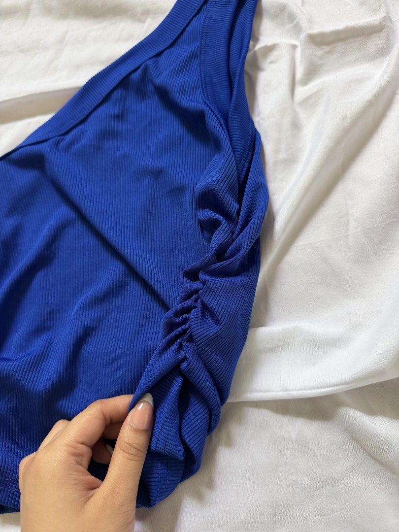 Blue One-Shoulder Ribbed Tank Top (Category: Sleeveless) located in Las Pinas. Submitted by ann.co. (Listing ID 1467683522, Image 3). Description: - Color: Royal blue - Design: One-shoulder neckline with side ruching - Material: Soft, stretchy ribbed knit - Fit: Sleeveless, easy to pair with high-waisted jeans or skirts .