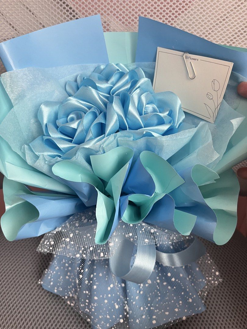 Blue Satin Rose Bouquet (Category: Flowers & Bouquets) located in Pasig City. Submitted by megistus (Listing ID 1467643237, Image 3). Description: ‼️PHP 200 LAST PRICE‼️ - Includes a blank gift card - bought from orange app rfs: di naibigay sa pagbibigyan mode of payment: gcash mode of delivery: lalamove *shipping fee is shouldered by buyer.
