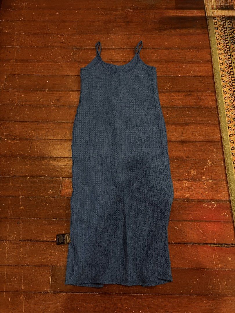 Blue waffle knit midi cami dress (Category: Dresses) located in Makati City. Submitted by margaaa01 (Listing ID 1467729335, Image 1). Description: - Color: Blue - Length: Midi (hits around mid-calf) - Material: Super stretchy textured waffle knit - Features: Thin adjustable spaghetti straps, scoop neckline, straight silhouette, slip-on style - Condition: Brand new with tags attached near the bottom seam - Best for: Warm weather, running errands, 